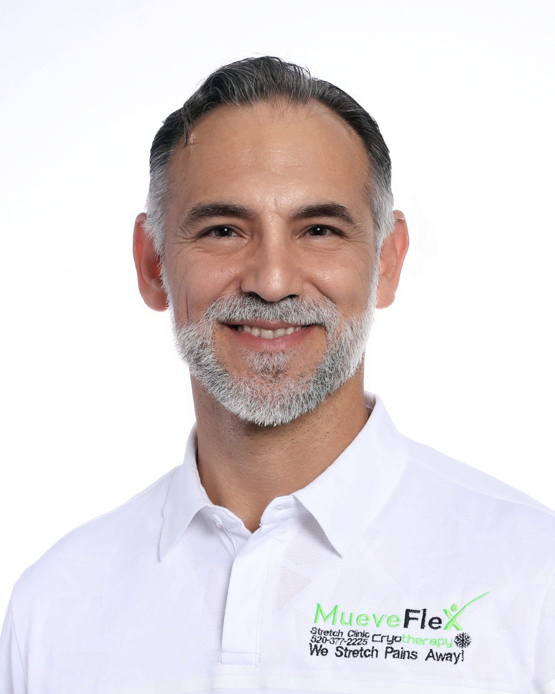 Dr. Jesus G. Bernal, founder of MueveFlex Wellness Center in Tucson, wearing a white branded polo shirt.